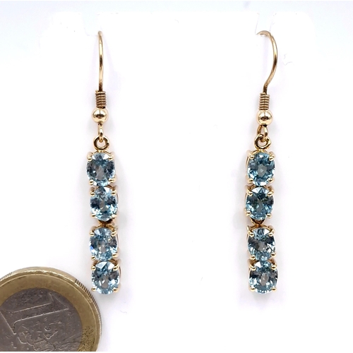 34 - Star Lot : A very attractive pair of nine carat gold four lovely blue  topaz drop earrings - suitabl... 