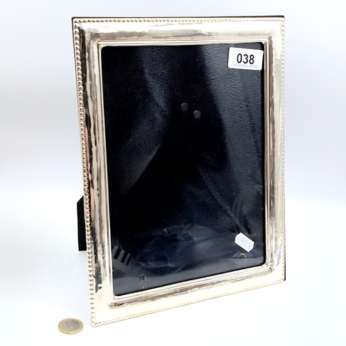 38 - A large glazed sterling silver photo frame with a dart surround. Internal measurements - 23.5 x 17.5... 