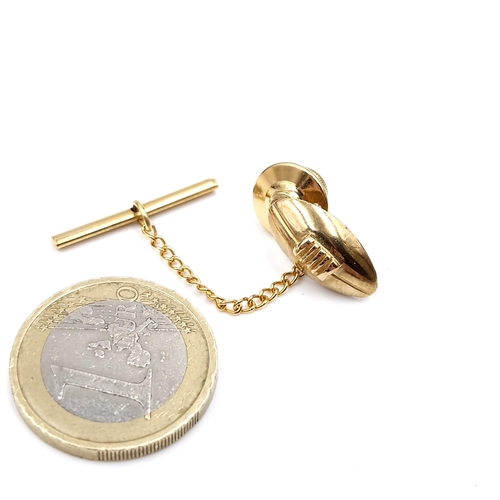 41 - A nine carat gold tie pin in the form of a Rugby ball. Weight - 3.4 grams. Comes in original box.