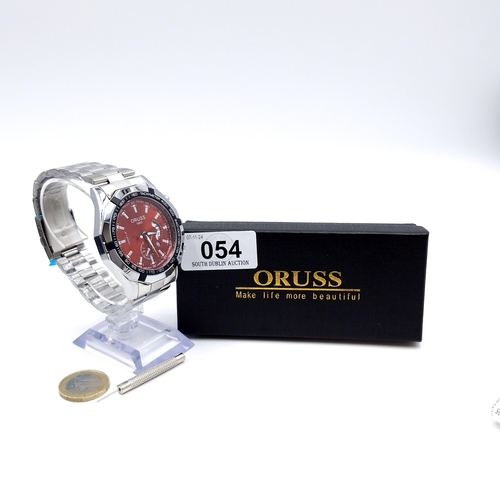 54 - An as new Oruss chronograph wristwatch with original bracelet. Watch strap sealed and appears to be ... 