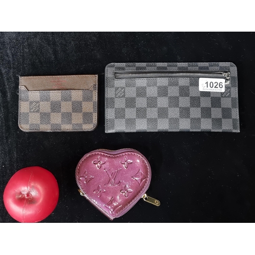 1026 - A trio of designer  wallets All marked Louis Vuitton including leather card holder, a playful Love H... 