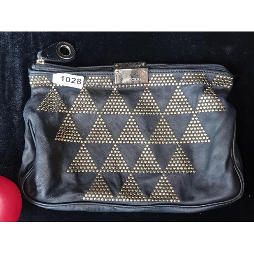 1028 - An original designer Jimmy Choo black leather gold studded zulu zipper top clutch bag. RRP: $279 Ser... 