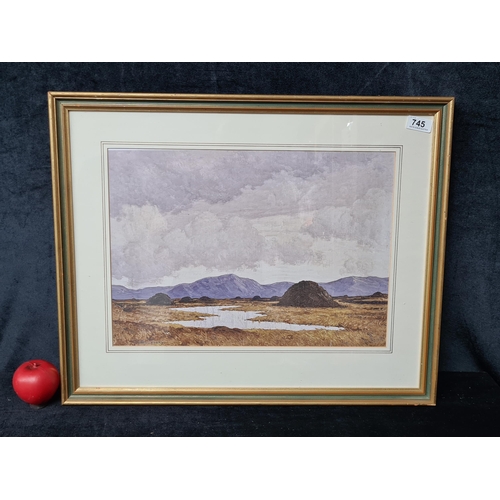 745 - A vintage print of a Paul Henry painting of peat stacks. Housed in a gilt frame behind glass. 

MM: ... 