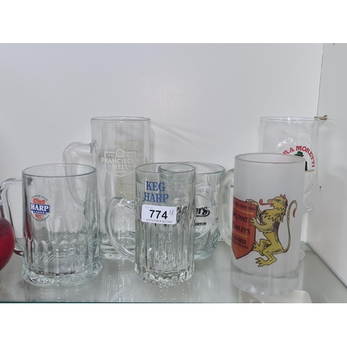 774 - A mixed lot of pub themed glassware including two Harp Lager tankards.