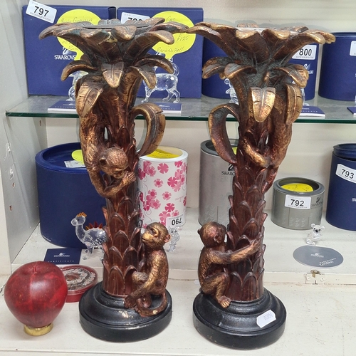 786 - A charming pair of tall candle holders in the form of palm trees.