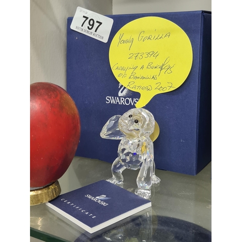 797 - A Swarovski figure of a young gorilla carrying a bunch of bananas. RRP £95.00 on thecrystallodge.co.... 