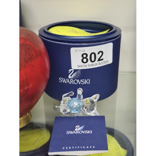 802 - A Swarovski figure of a kitten lying playing with a blue ball of wool. RRP £85.00 on thecrystallodge... 