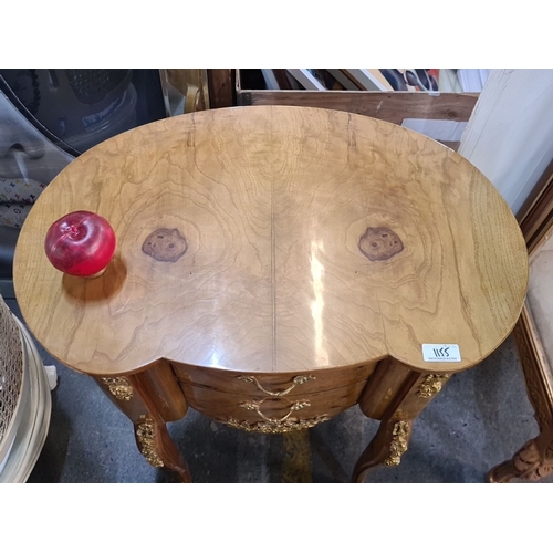 1155 - Star lot : A French-style burl wood vanity with ornate gold accents, curved design, and three drawer... 