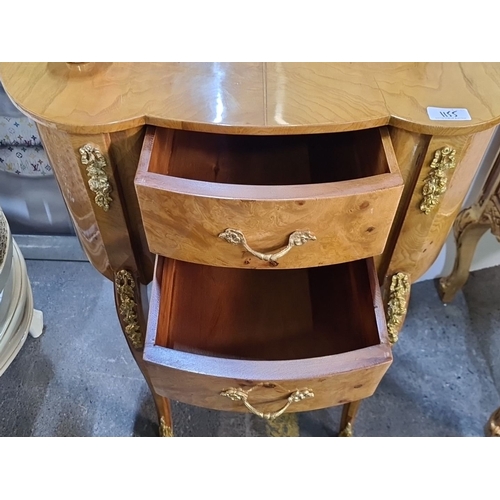 1155 - Star lot : A French-style burl wood vanity with ornate gold accents, curved design, and three drawer... 