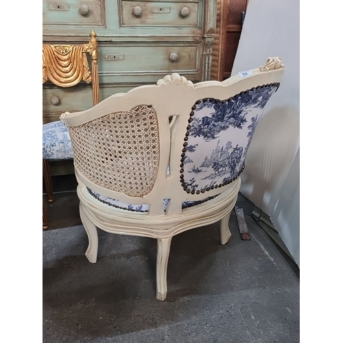 1156 - Star Lot : French-style bergère chair with cane panels, blue toile upholstery, and carved wood frame... 