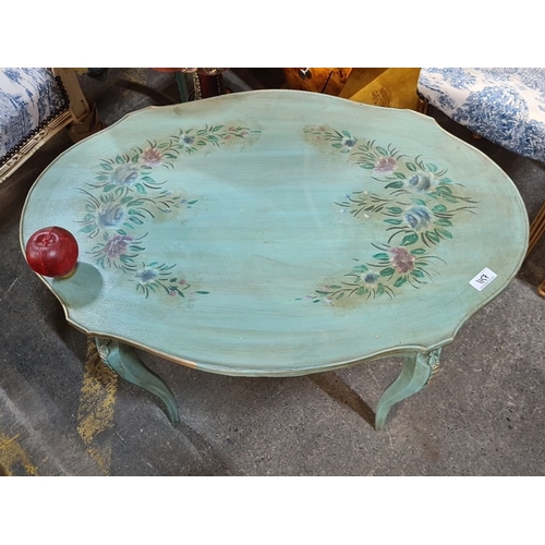 1157 - Star Lot : Wooden oval painted coffee  table, painted with floral motifs on a green surface, featuri... 