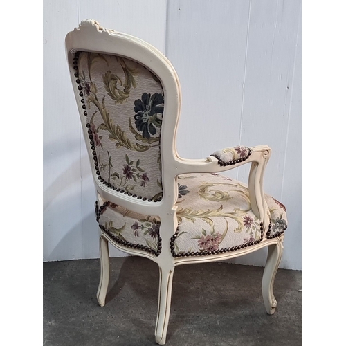 1174 - Star Lot : A Rococo-style upholstered armchair with floral tapestry and carved wooden frame, featuri... 