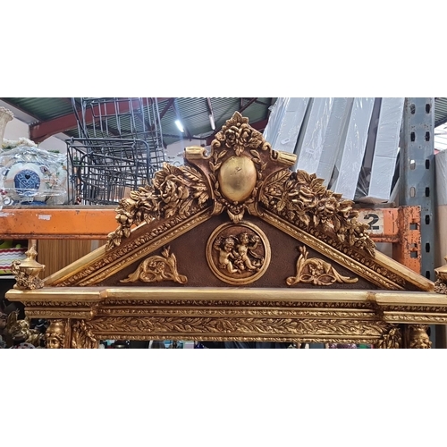 1184 - Super Star Lot A very large Ornately carved giltwood overmantel mirror, featuring a pediment with ch... 