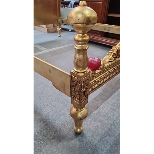 1189 - Star Lot : A majestic Gilded wooden bed frame featuring ornate detailing and plush yellow upholstery... 