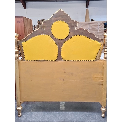 1189 - Star Lot : A majestic Gilded wooden bed frame featuring ornate detailing and plush yellow upholstery... 