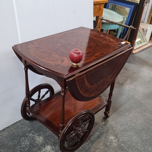 1192 - Star Lot : A very decorative tea trolley with inlaid floral marquetry, drop-leaf design, brass handl... 