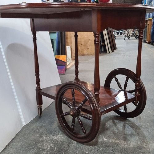 1192 - Star Lot : A very decorative tea trolley with inlaid floral marquetry, drop-leaf design, brass handl... 