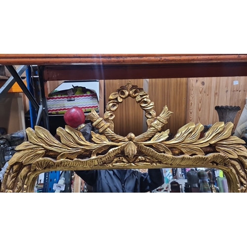 1197 - Star Lot : a large impressive Giltwood mirror with intricate carved laurel leaf and fruit design, Cl... 