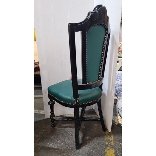 1200 - Star Lot : Victorian ebonized chair featuring green tufted upholstery and intricate gilt stenciling.... 