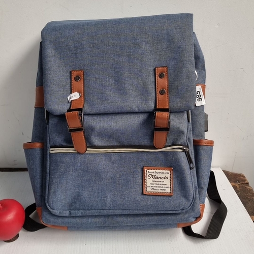 985 - Mancio denim backpack with leather accents features a front zipper pocket and adjustable straps. Sig... 