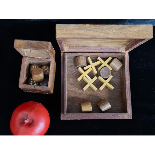 207 - Two wooden games boxes including a noughts and crosses board and pieces and a brass inlayed dice box... 