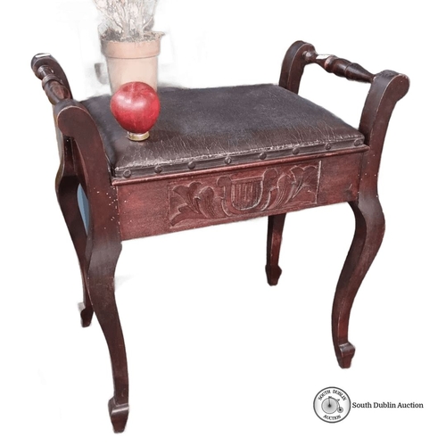 1207 - Mahogany piano stool with carved lyre motif, featuring a lift-up seat for storage, from the early 20... 