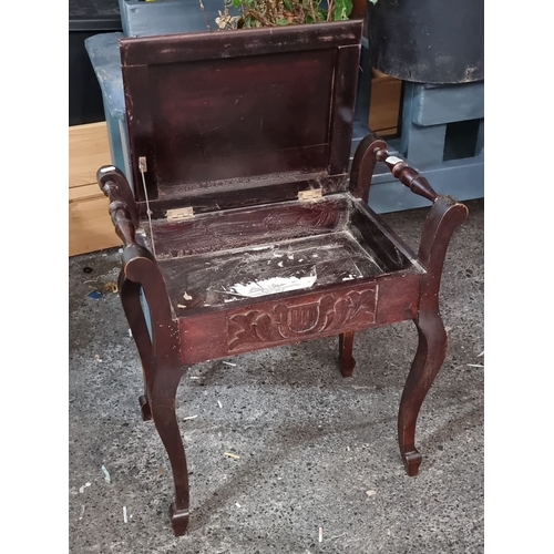 1207 - Mahogany piano stool with carved lyre motif, featuring a lift-up seat for storage, from the early 20... 