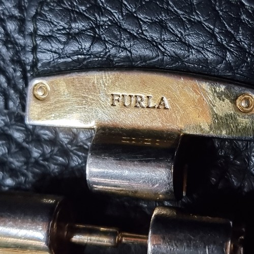 1032 - An original designer Furla grained leather shoulder bag complete with brass hardware and dust bag. R... 