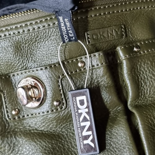 1034 - An original olive green leather ladies DKNY shoulder bag. As new with original tags. RRP €119