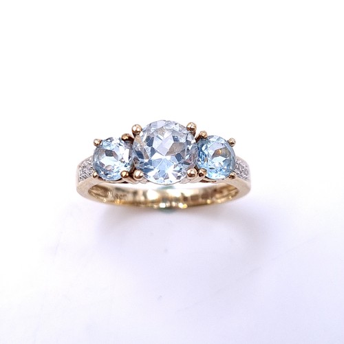 1 - Star Lot : A very good quality three stone Aquamarine stone ring with diamond shoulders set in nine ... 