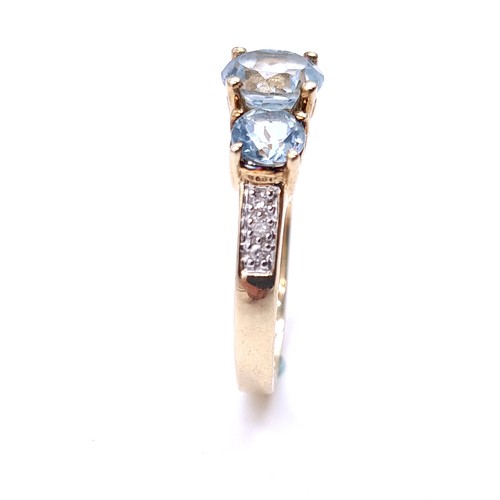 1 - Star Lot : A very good quality three stone Aquamarine stone ring with diamond shoulders set in nine ... 