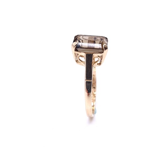 2 - A nine carat gold smoky quartz ring with claw mount. Size - M 1/2. Weight - 2.4 grams.