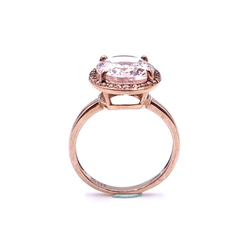 3 - Star Lot : A very unusual nine carat gold morganite stone ring with a diamond cluster surround. Ring... 