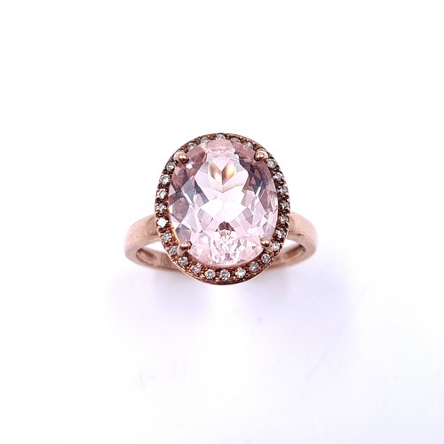 3 - Star Lot : A very unusual nine carat gold morganite stone ring with a diamond cluster surround. Ring... 