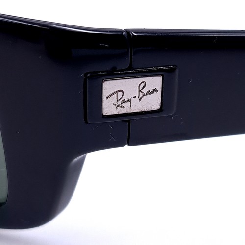 15 - A pair of wrap round Ray-Ban sunglasses 'Made in Italy'. Lenses clear . Comes in Ray-Ban box.