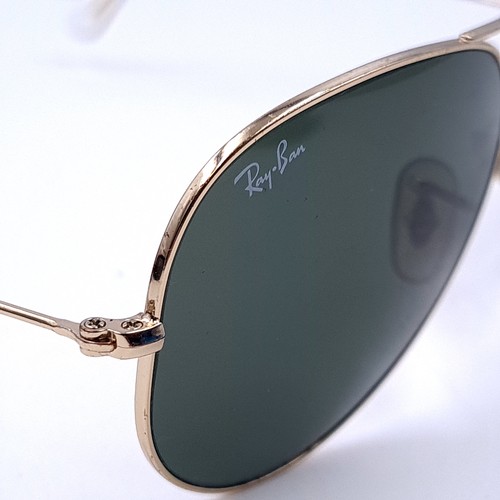 23 - A pair of Ray-Ban aviator style metal framed sunglasses. Lenses clear with no marks or scratches. Co... 