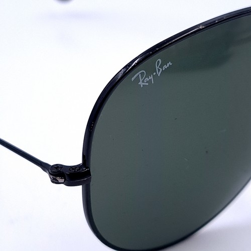 24 - A pair of Ray-Ban black framed aviator style sunglasses. Lenses clear with no marks or scratches. Co... 