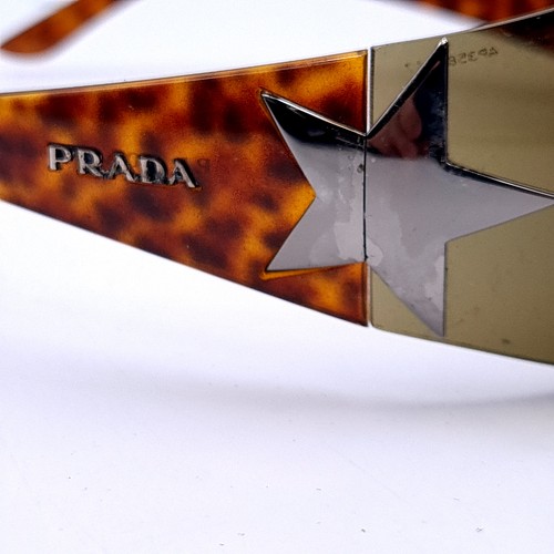 28 - A pair of Prada 'Made in Italy' wrap round sunglasses. Serial nos to frames. Comes in presentation b... 