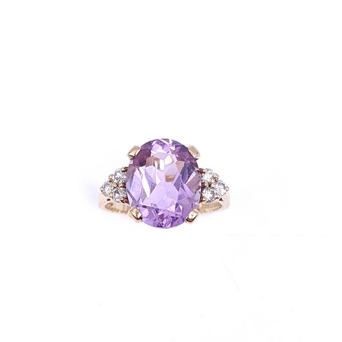 29 - Star Lot : A nine carat gold amethyst stone ring with gemstone accents. Size - K 1/2. Weight - 3.3 g... 