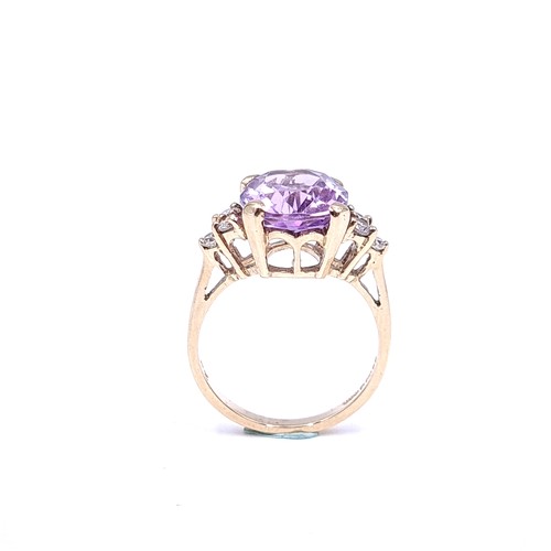 29 - Star Lot : A nine carat gold amethyst stone ring with gemstone accents. Size - K 1/2. Weight - 3.3 g... 