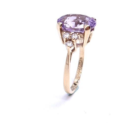 29 - Star Lot : A nine carat gold amethyst stone ring with gemstone accents. Size - K 1/2. Weight - 3.3 g... 