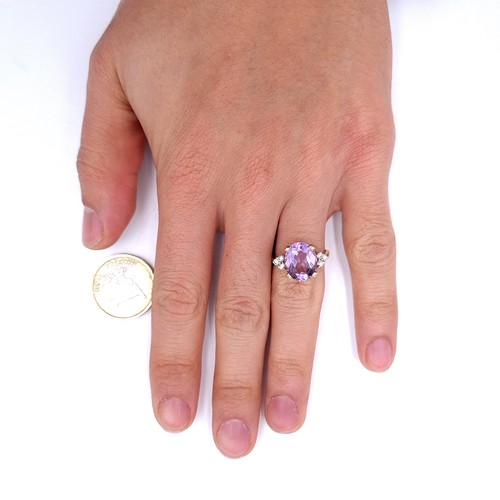 29 - Star Lot : A nine carat gold amethyst stone ring with gemstone accents. Size - K 1/2. Weight - 3.3 g... 