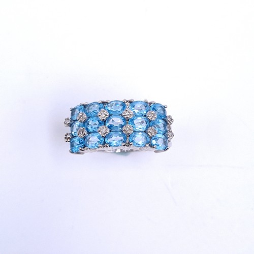 31 - A nine carat white gold ring set with blue topaz stone cluster mount with diamonds. Ring size - N. W... 