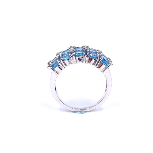 31 - A nine carat white gold ring set with blue topaz stone cluster mount with diamonds. Ring size - N. W... 