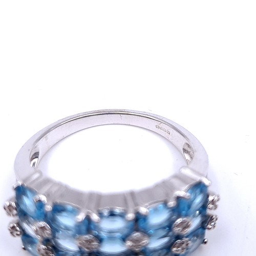 31 - A nine carat white gold ring set with blue topaz stone cluster mount with diamonds. Ring size - N. W... 