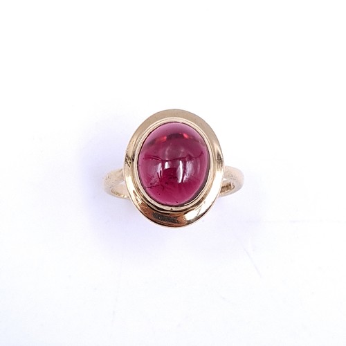 33 - An excellent example of a cabochon garnet stone ring set in nine carat gold. Ring size - P. Weight -... 