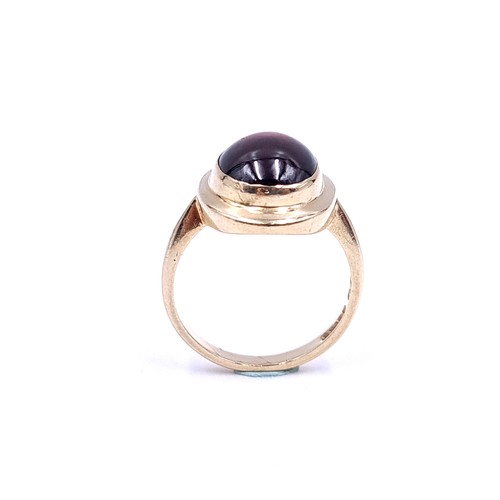 33 - An excellent example of a cabochon garnet stone ring set in nine carat gold. Ring size - P. Weight -... 