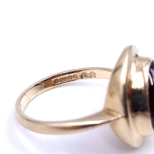 33 - An excellent example of a cabochon garnet stone ring set in nine carat gold. Ring size - P. Weight -... 