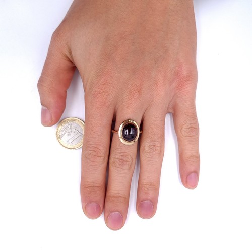 33 - An excellent example of a cabochon garnet stone ring set in nine carat gold. Ring size - P. Weight -... 