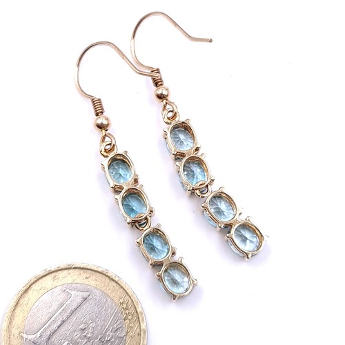 34 - Star Lot : A very attractive pair of nine carat gold four lovely blue  topaz drop earrings - suitabl... 